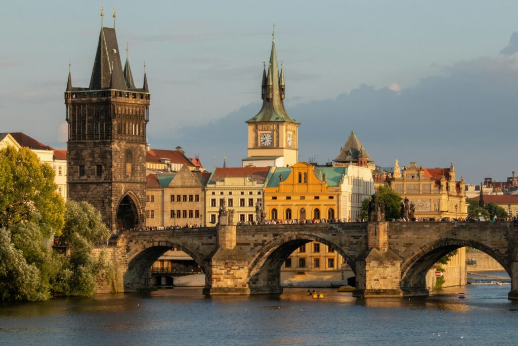 Prágai panoráma a Károly híddal, Moldvával és a háttérben a prágai várral naplementében